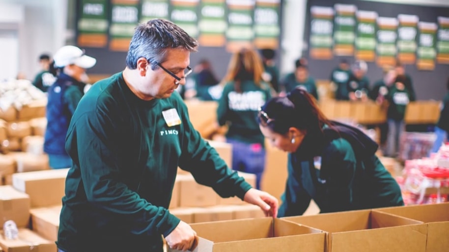 PIMCO volunteer packing boxes